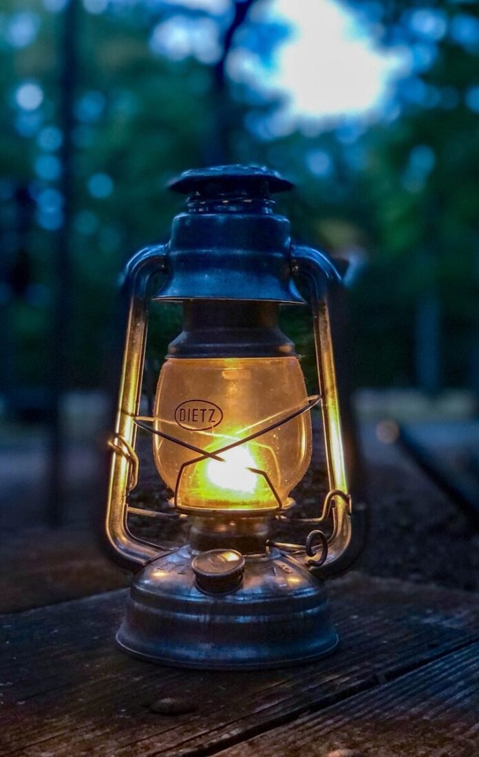 Photo by Jordan Davis turned-on lantern on brown wooden table