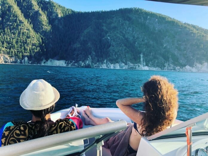 Photo by Ericka Mendoza a couple of people sitting on a boat in the water