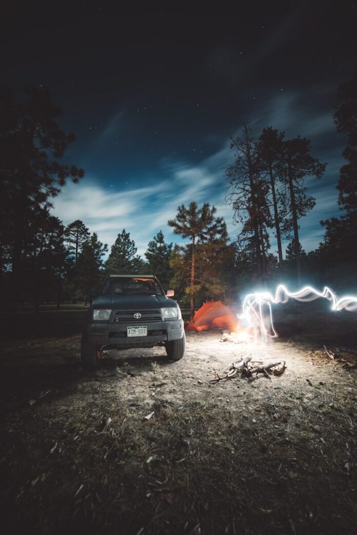 Photo by Andrew Sterling white car near bonfire during night time
