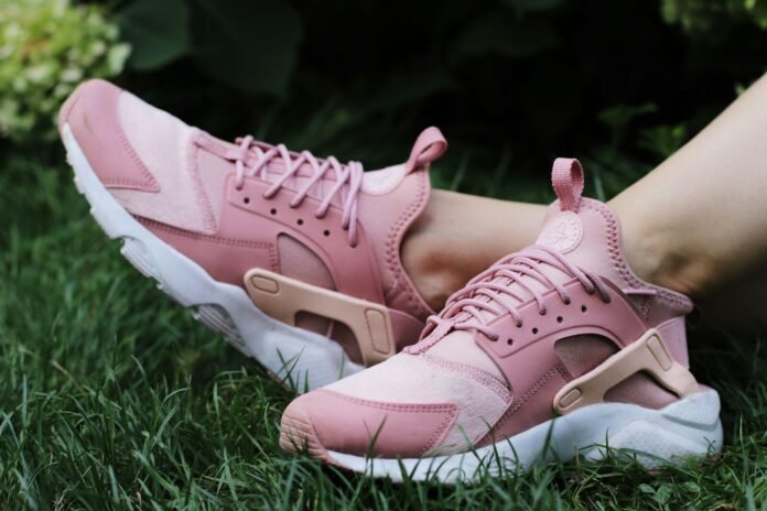 Photo by Barbora Polednová person wearing pair of pink lace up low top sneakers