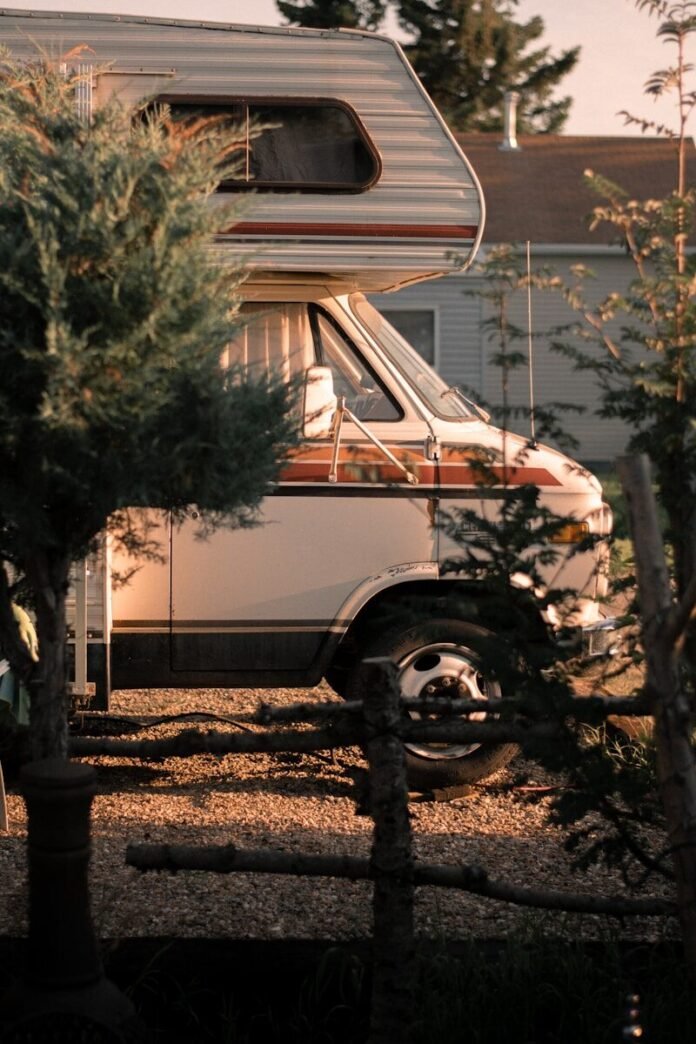 Photo by Teanna Morgan white and brown van near green tree during daytime